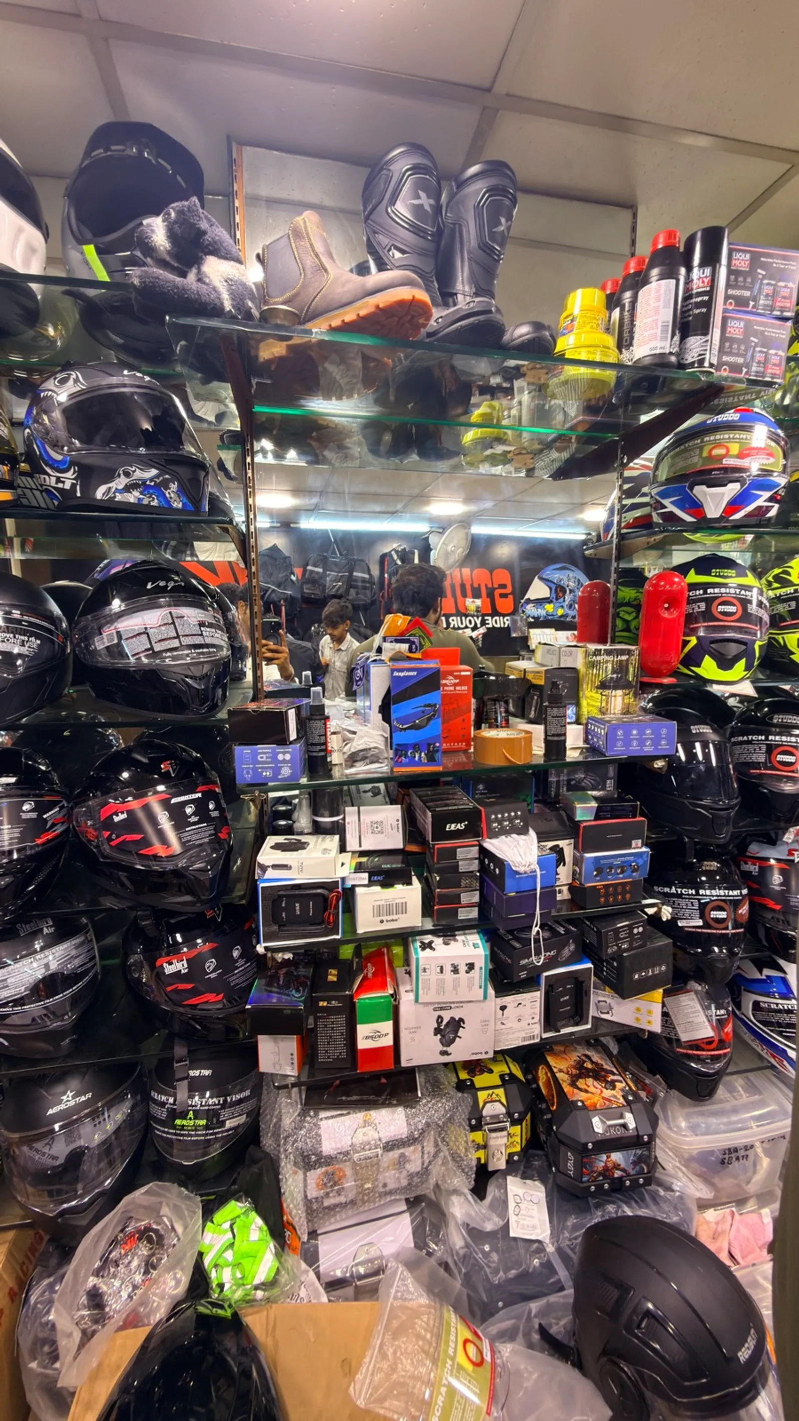 A shelf full of bike accessories, lights and gadgets at Speed World