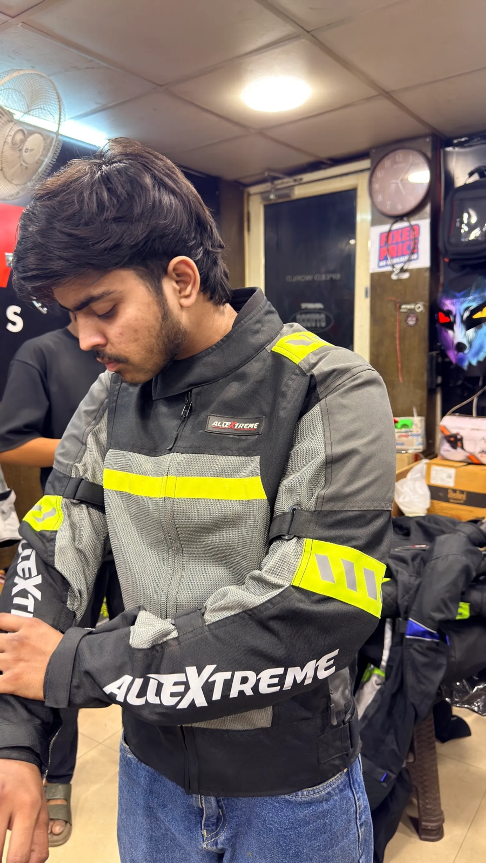 A rider trying on an AllExtreme riding jacket at Speed World