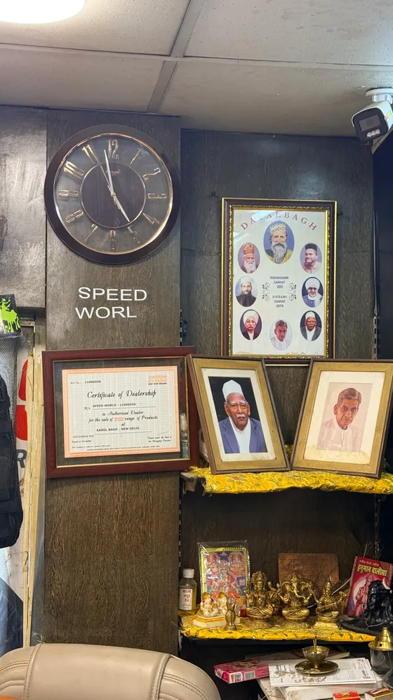 The Speed World sign and framed certificates on the shop wall
