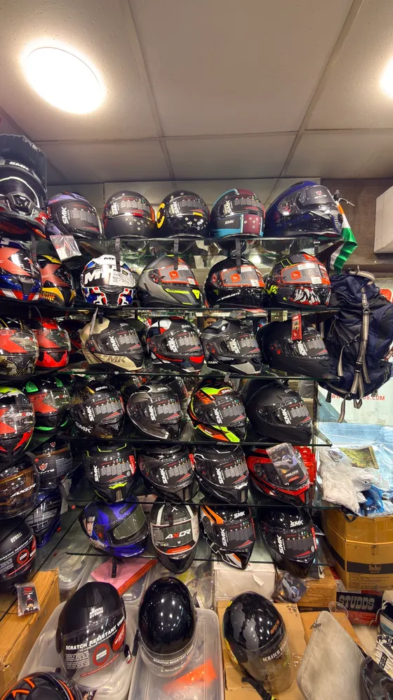 A full wall of full-face helmets at Speed World