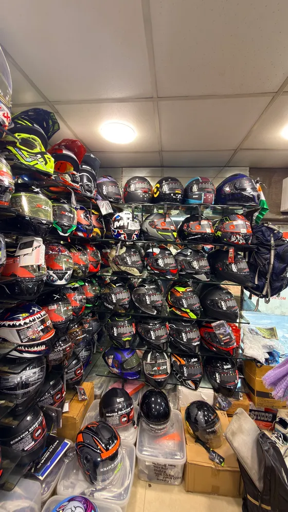 Corner-to-corner wall of helmets at Speed World