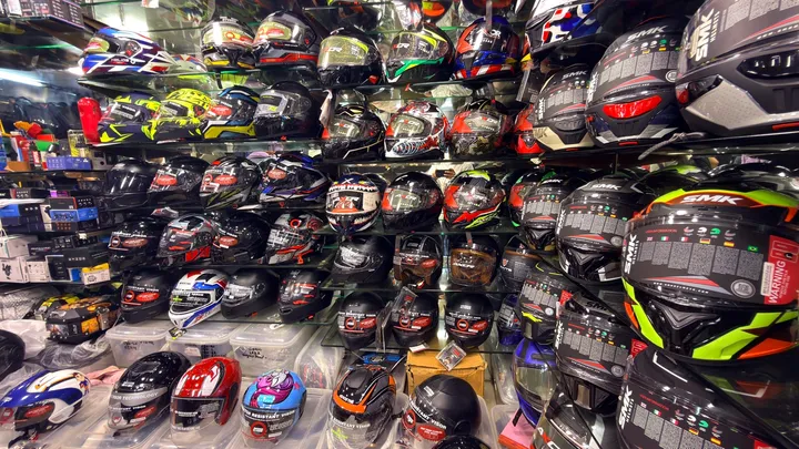 A wall of helmets across types and sizes at Speed World